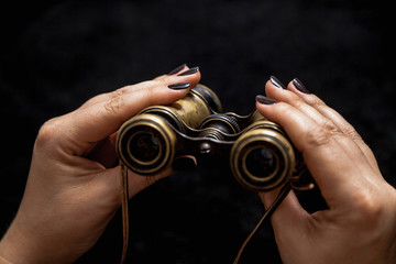 Ancient binoculars in female hands