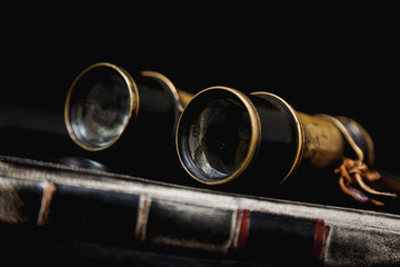 Ancient binoculars lie on book