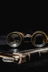Ancient binoculars lie on book