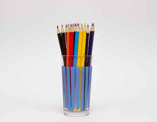 colored pencils in a glass isolated on business background