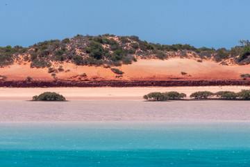 Broome, WA, Australia - November 29, 2009: Closeup of Horizontal line made by red dunes with some...
