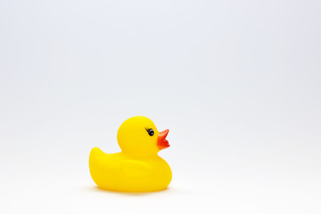 Cute yellow rubber duck isolated over white background