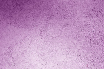 Grungy cement wall in purple color.