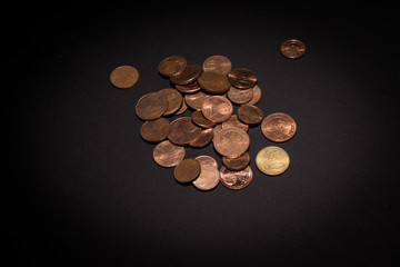 Pile of money coins isolated on black background