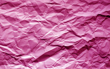 Naklejka premium Crumpled sheet of paper with blur effect in pink tone.