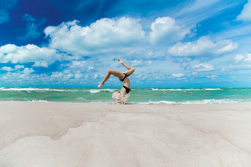 Fototapeta na wymiar yoga on the sea beach