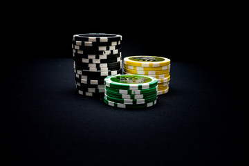Tower of poker chips on a black background