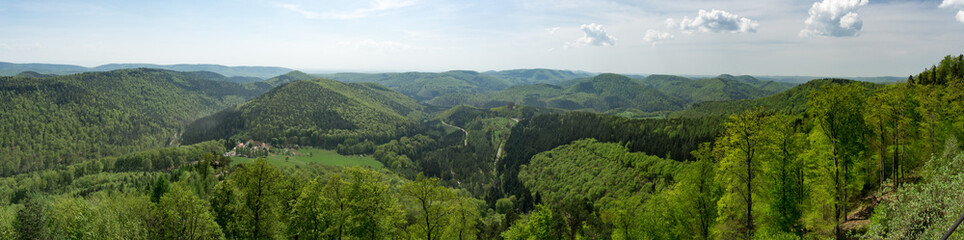 Fototapeta na wymiar Panorma of middle range mountain in Vosges north east France. Alsace region of north east France. Landscape full of mountains, flowers, trees ,sun, villages and forests.