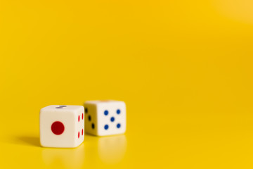 white dice on yellow background
