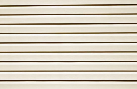 Plastic siding surface in brown tone.