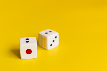 white dice on yellow background
