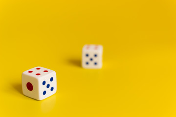 white dice on yellow background