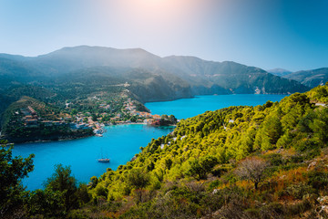 Panoramic view to Assos village Kefalonia. Greece. Beautiful turquoise colored bay lagoon water surrounded by pine and cypress trees along the coastline