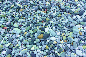 Abstract texture of the colored stones on the beach.