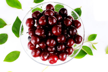 Background with cherry in a glass bowl top view