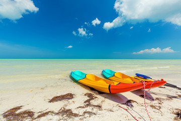 Canoes on pristine sunny tropical beach