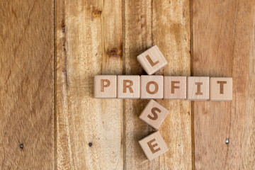Wooden block stack business concept, profit and lose letters.