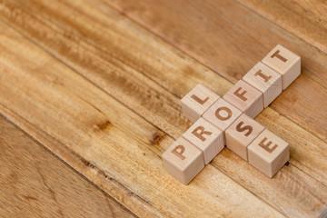 Wooden block stack business concept, profit and lose letters.