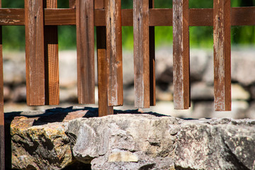 Decorative wooden fence on stone