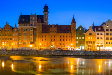 Fototapeta na wymiar Old town of Gdansk reflected in Motlawa river at dusk, Poland