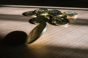 Bitcoin BTC crypto currency coin falling on table