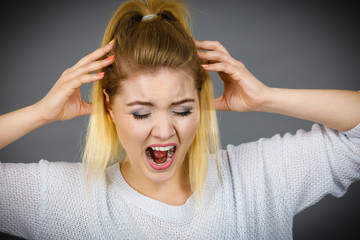 Unhappy woman screaming and yelling in pain