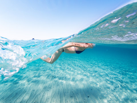 Girl Swimming On The Sea, Half Underwater Phtography