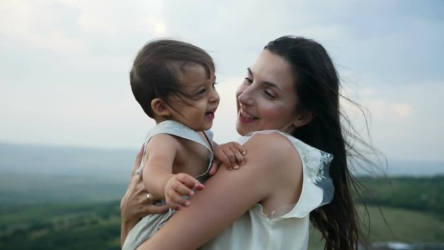 mom walks with her son standing on the mountain