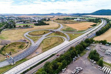 Fototapeta na wymiar Aerial view of a highway intersection with a clover-leaf interchange Germany Koblenz