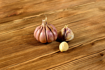 Several garlic bulbs on wooden background