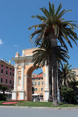Fototapeta na wymiar Finale Ligure, Arco e Palme, Liguria, Italia, Arch and Palms in Finale Ligure village in Liguria, Italy
