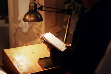 priest holding holy bible book and reading at wedding ceremony. spiritual moment in church in...