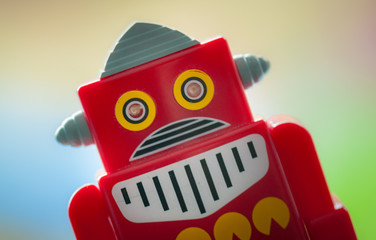 Red retro toy robot on a bright background