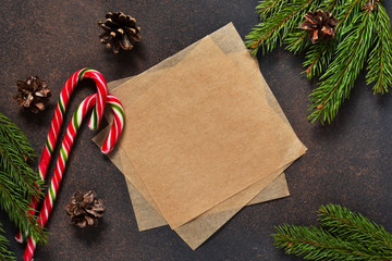 New Year card. Christmas tree with cones and candies on a brown background with space under the text.