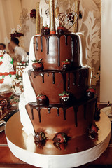 wedding cake. big delicious chocolate and golden wedding cake with strawberries and fireworks,...