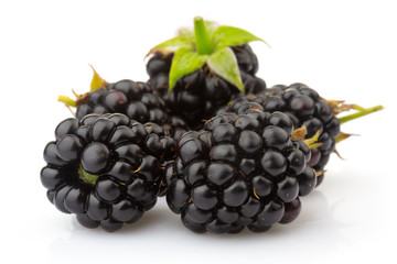 Ripe blackberries with green leaves isolated on white