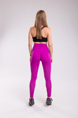 Fototapeta premium Rear view of sportive woman wearing sexy leggings. Back view of sporty woman