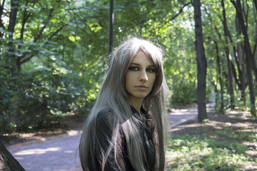 Naklejka premium Portrait of girl with long hair in park