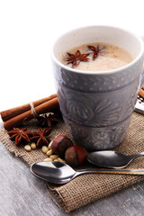 Masala tea in ceramic cup with winter spices.