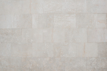 Old grey marble brick wall in Spain. Texture of marbles bricks