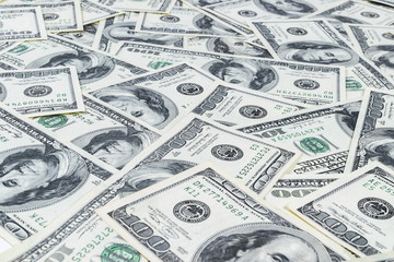 Stack of one hundred dollar bills. Stack of cash money in hundred dollar banknotes. Heap of hundred dollar bills background. Concept of financial success.