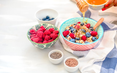 High protein healthy breakfast, buckwheat porridge with blueberries, raspberries, flax seeds and honey Closeup view, selective focus
