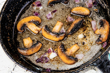 Roasted champignons with onion.