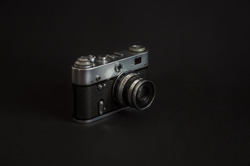 Old analog camera on a black background.