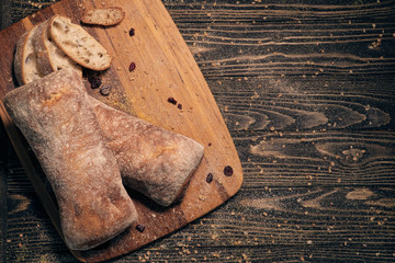 delicious white ciabatta slices on wood;
