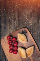 fresh tasty bun set with tomatoes on wood;