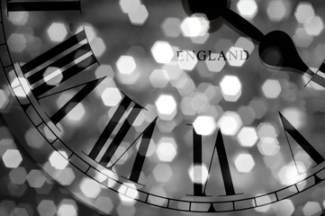 Clock face with roman numerals abstract closeup with bokeh effect