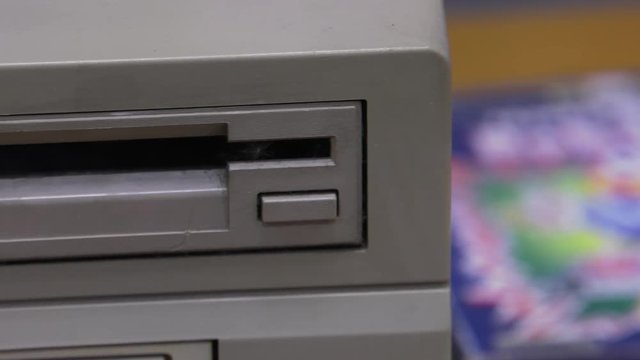 Floppy Disk Drive. Computer or game console from the 90s. Old retro style. , Panning, closeup. 