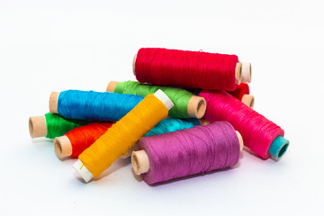 Pile of colored thread coils on white background
