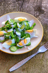 Dietary salad with chicken eggs, green onions, cucumbers and yogurt